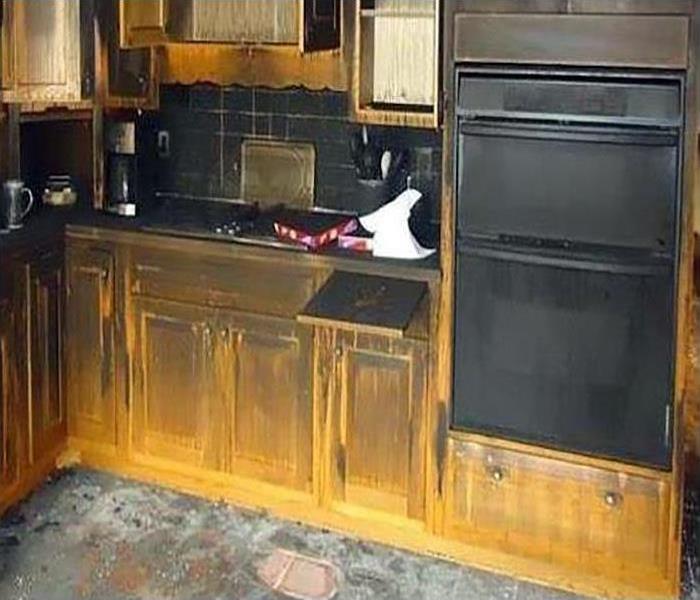fire damaged kitchen covered in soot