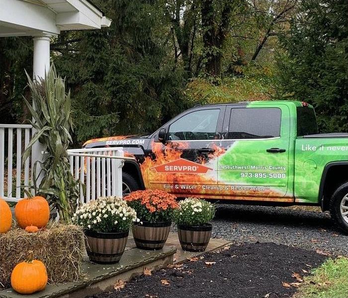 SERVPRO truck in front of home decorated for fall