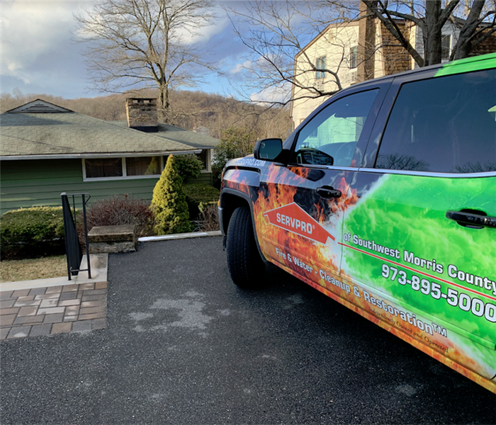 a SERVPRO vehicle parked outside of a house