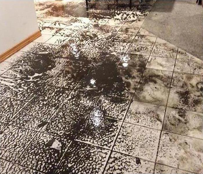 A muddy floor in a home after a flood damage disaster