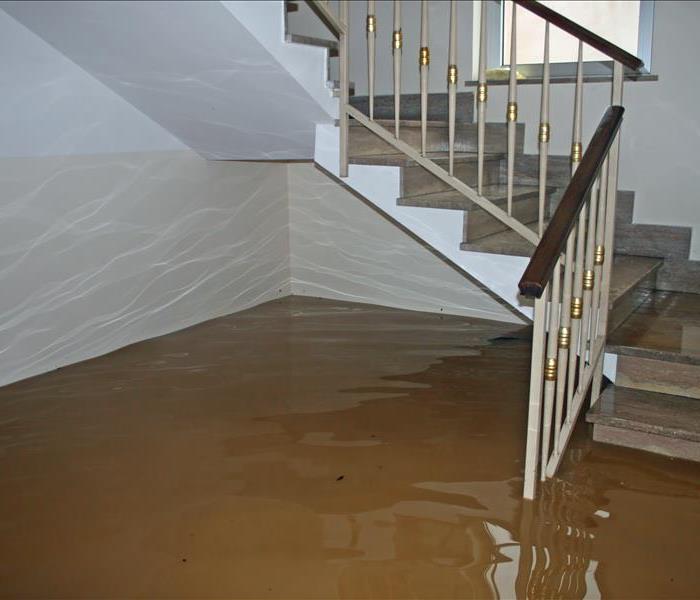 an area of the house with stairs that is flooded