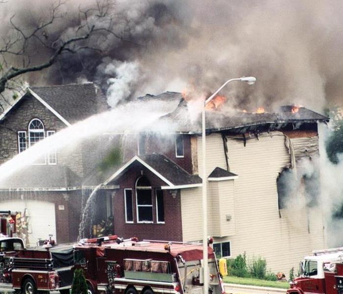 Firefighters fighting a fire in a home. 