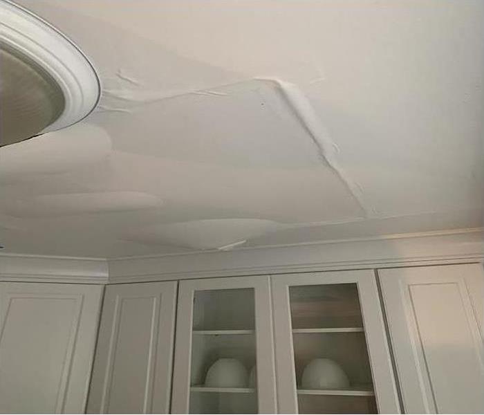 A ceiling in a home covered in water spots after a water damage disaster